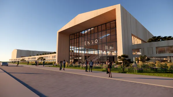 A tan building with glass windows and the Enso logo on the front.