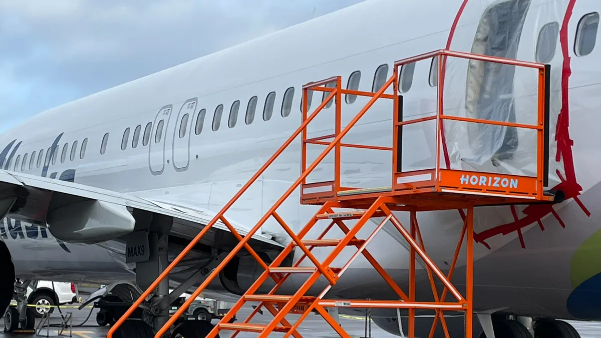 A clear plastic covers a hole of a Boeing 737-9 Max aircraft.