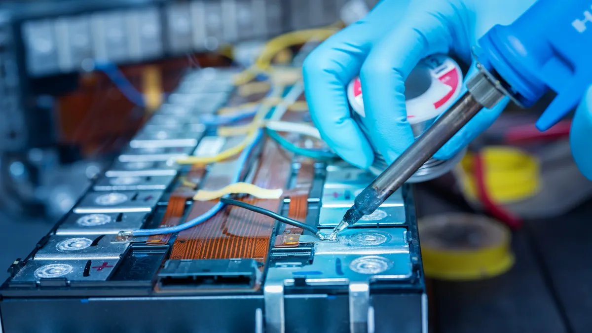 A technician works on a lithium-ion battery.