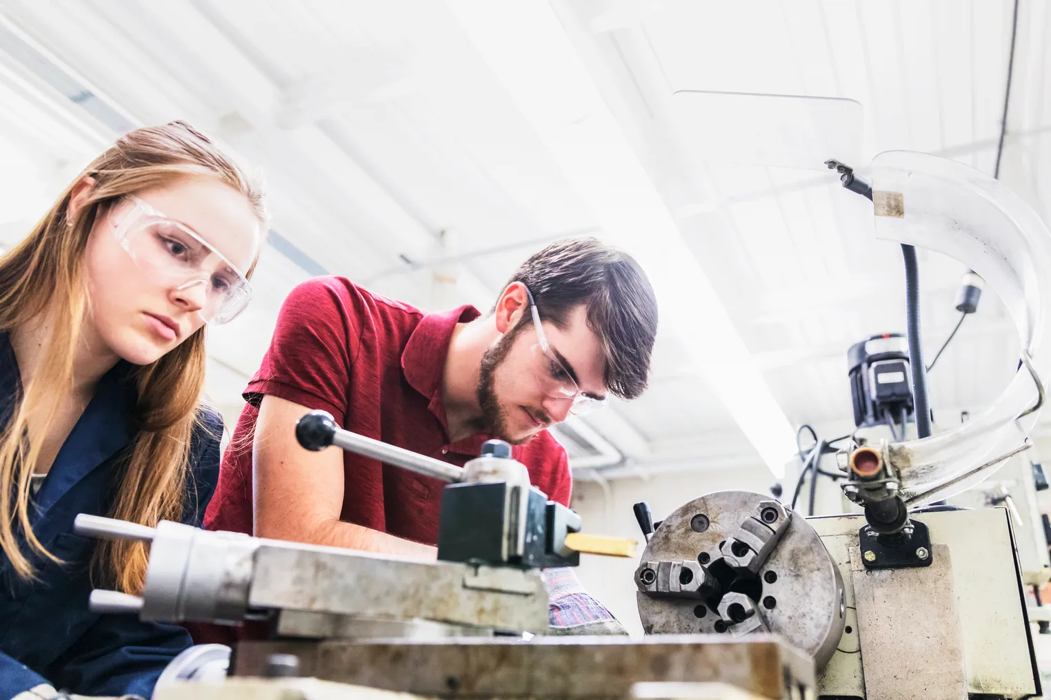 Engineers working on a heavy machinery for their project work