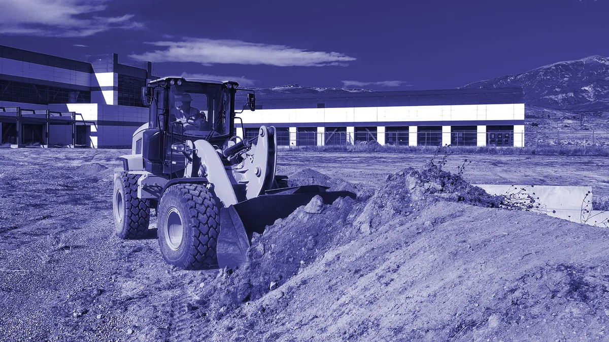 A bulldozer getting land ready for a semiconductor plant