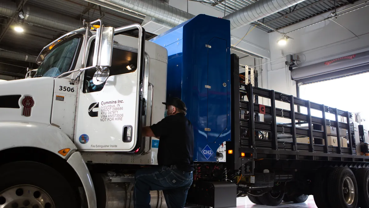 A hydrogen truck and driver prepare to leave a Cummins plant